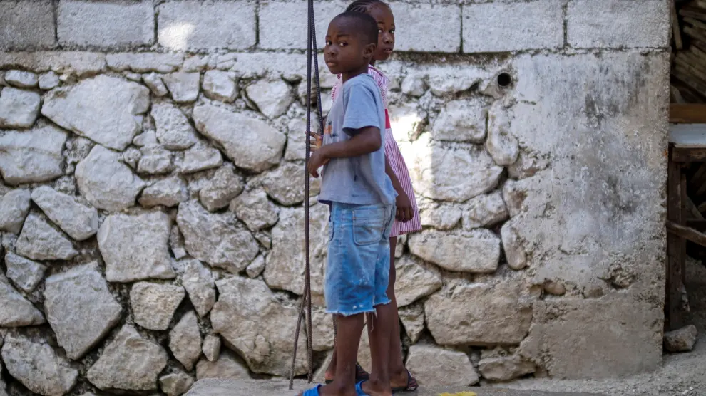 Two children look a the camera while playing in Port-au-Prince