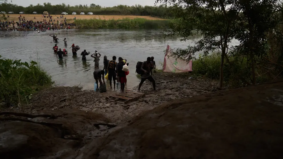 Ciudad Acuna (Mexico), 21/09/2021.- Migrants, many of them Haitian, cross the Rio Grande river back and forth from the United States and Mexico, to camp after a lack of supplies are given to them in the USA in Ciudad Acuna, Mexico, 21 September 2021. According to reports more than 14,000 people have crossed the Rio Grande river from Mexico creating a humanitarian crisis. The Biden administration has started to fly the migrants back to Haiti according to federal officials. (Estados Unidos) EFE/EPA/ALLISON DINNER
 MEXICO USA MIGRATION