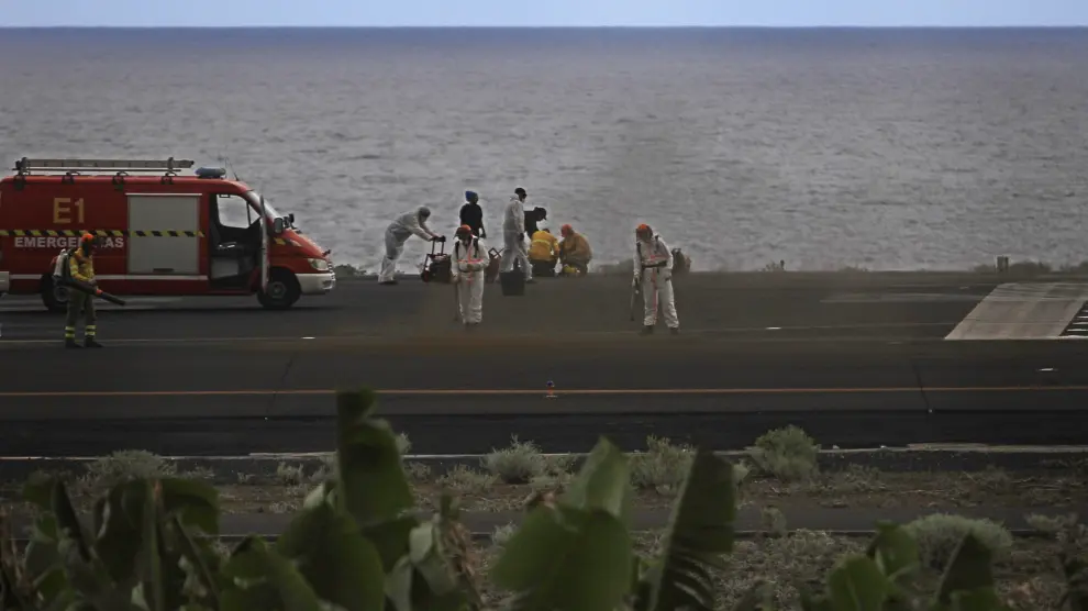 Operarios limpian de cenizas una pista del aeropuerto de La Palma,