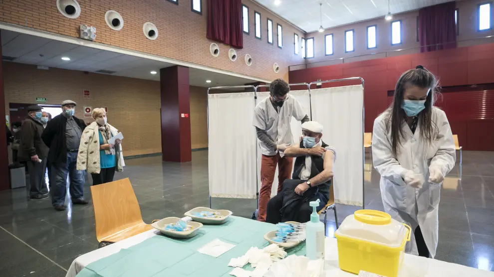 Varios pacientes mayores de 70 años acuden a ponerse la doble vacuna (de la gripe y la covid) al centro de salud de Garrapinillos, en Zaragoza.
