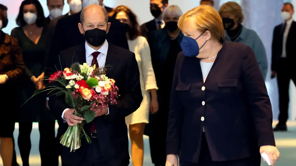 Olaf Scholz junto a Angela Merkel este miércoles