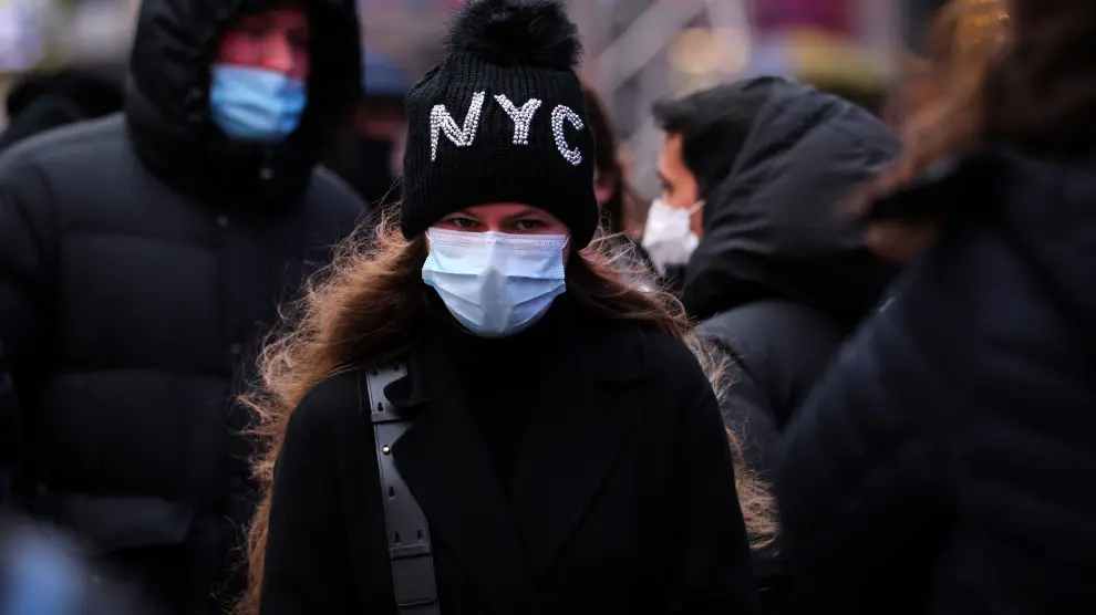 A person waits in a queue for a coronavirus disease (COVID-19) test in Times Square as the Omicron coronavirus variant continues to spread in Manhattan, New York City