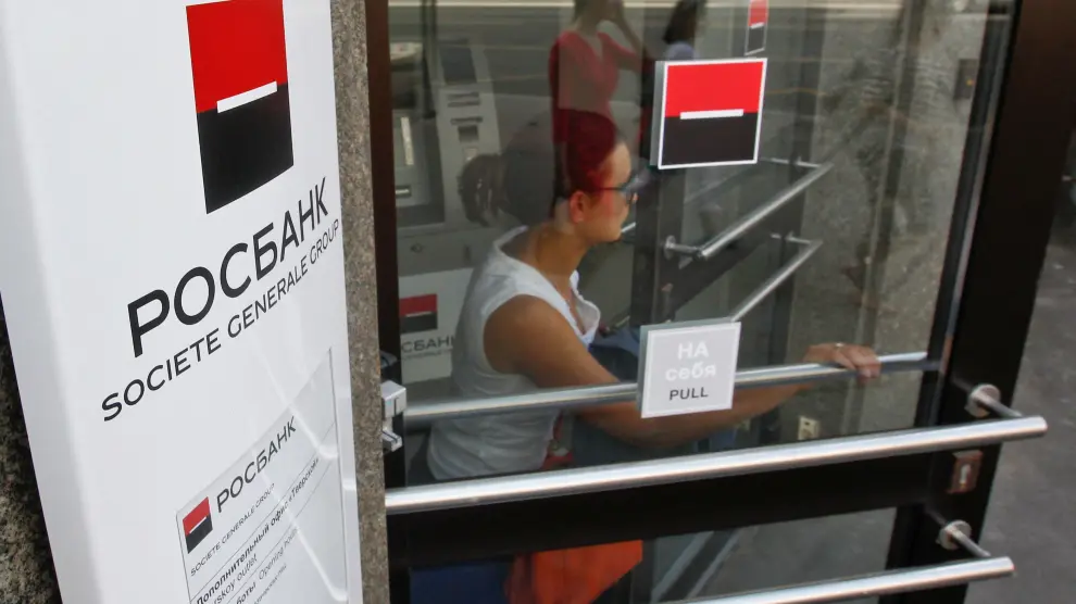 FILE PHOTO: Woman walks out of an office of Rosbank, a Russian unit of SocGen, in central Moscow