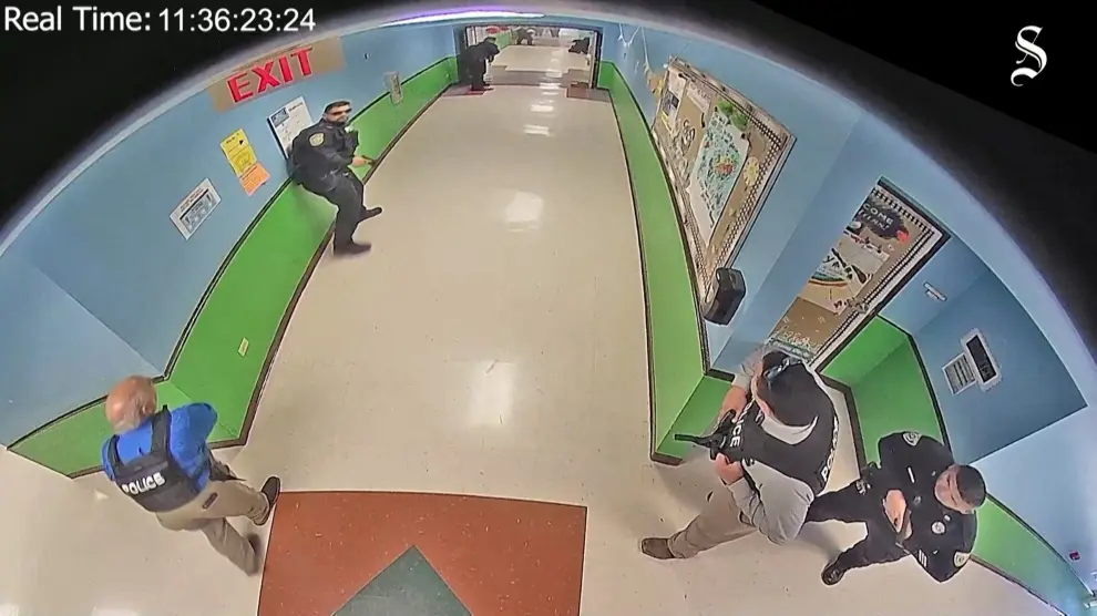 Salvador Ramos enters Robb Elementary school holding a rifle before killing 19 children and two teachers in Uvalde, Texas, U.S. May 24, 2022 in a still image from school surveillance video obtained by the Austin American-Statesman newspaper. Austin American-Statesman/Handout via REUTERS. NO RESALES. NO ARCHIVES. MANDATORY CREDIT TEXAS-SHOOTING/