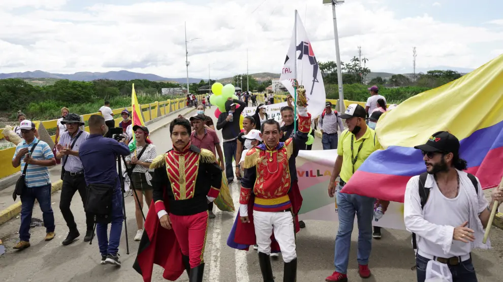 People cross the Simon Bolivar International Bridge on the border between Colombia and Venezuela to attend a political event in San Antonio del Tachira during the swearing-in ceremony of Colombia's President-elect Gustav
