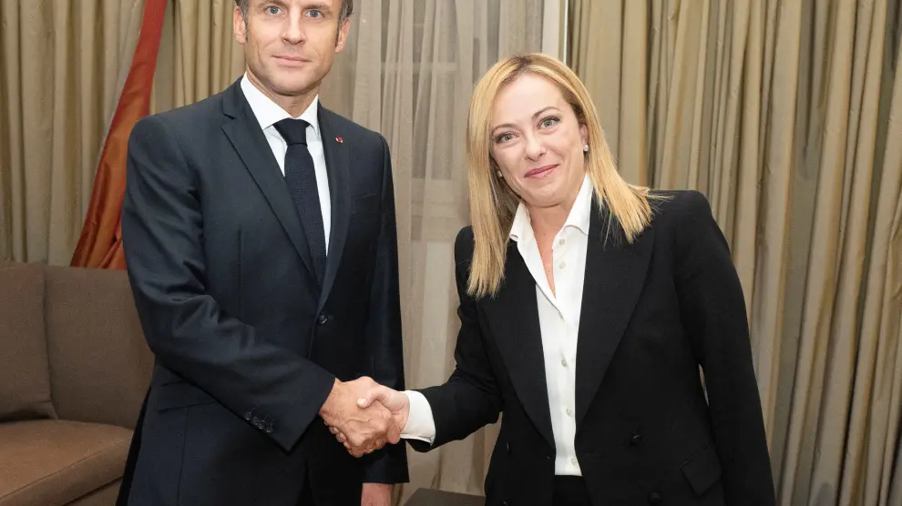 Italian Prime Minister Giorgia Meloni shakes hands with French President Emmanuel Macron during a meeting in Rome