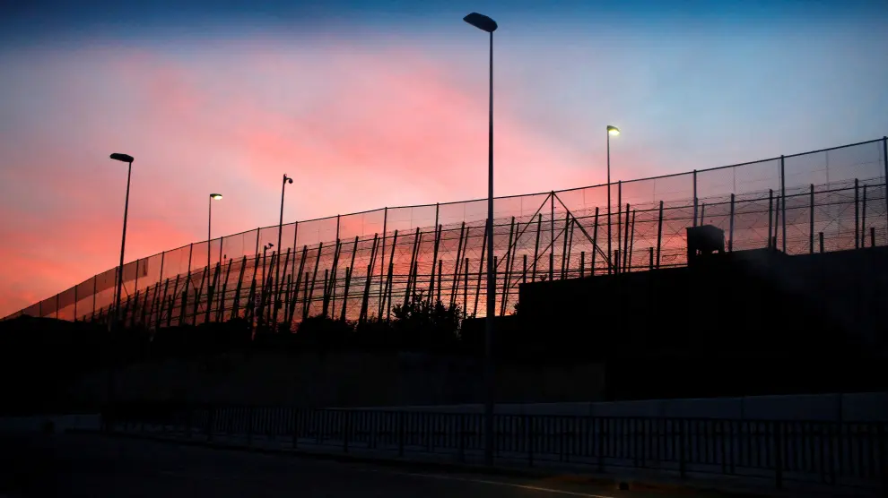 FILE PHOTO: The border fence between Morocco and Spain's north African enclave Melilla is seen along a road