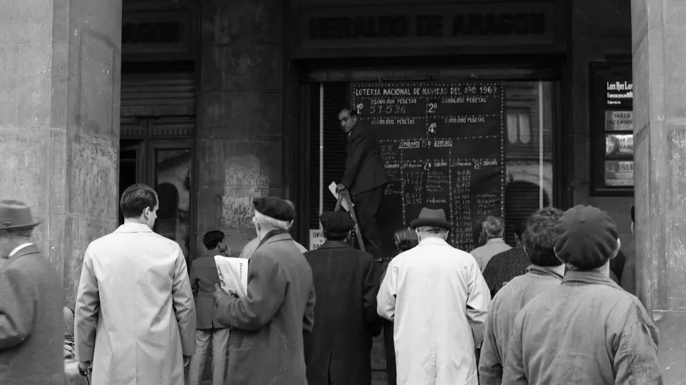 La gente mira expectante los números premiados del sorteo del Gordo de la Lotería de Navidad el 22 de diciembre de 1969.