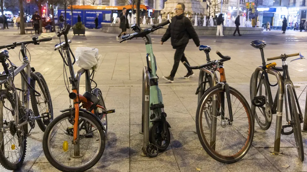 Varias bicicletas y un patinete aparcado en la plaza de España de Zaragoza.