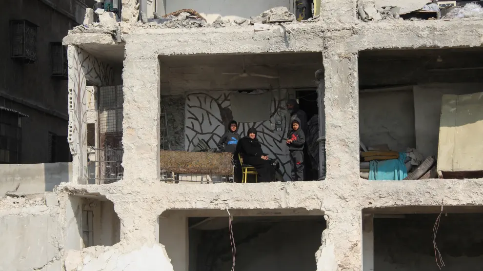 Amina Raslan y sus hijos, en su vivienda destrozada por el terremoto y la guerra en Alepo.