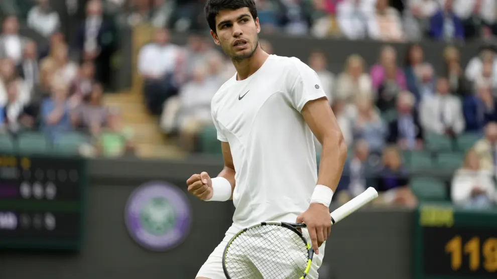 Spain's Carlos Alcaraz celebrates after winning a point against Jeremy Chardy of France in a first round men's singles match on day two of the Wimbledon tennis championships in London, Tuesday, July 4, 2023. (AP Photo/Kirsty Wigglesworth)
