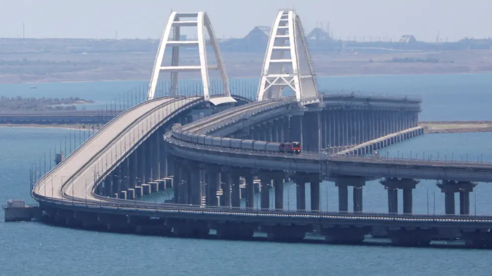 A train moves along the Crimean Bridge, a section of which was damaged by an alleged overnight attack, as seen from the city of Kerch, Crimea, July 17, 2023. REUTERS/Alexey Pavlishak