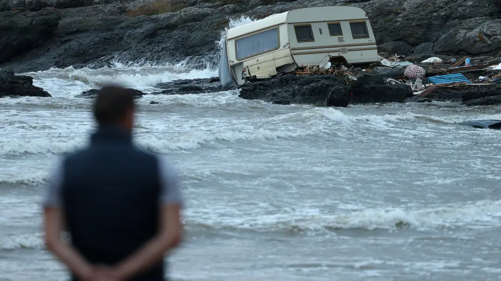 A man looks at a damaged camping trailer, washed away to the shore following severe flooding in Tsarevo, on the Black Sea coast, Bulgaria, September 6, 2023. REUTERS/Stoyan Nenov