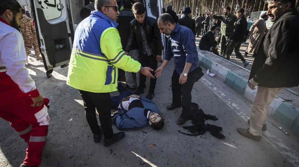 ADDS SOURCE - An injured man gets aid after an explosion in Kerman, Iran, Wednesday, Jan. 3, 2024. Iran says the deadly twin bomb blasts occurred at an event honoring a prominent Iranian general slain in a U.S. airstrike in 2020. (Mahdi Karbakhsh Ravari/Mehr News Agnecy via AP)