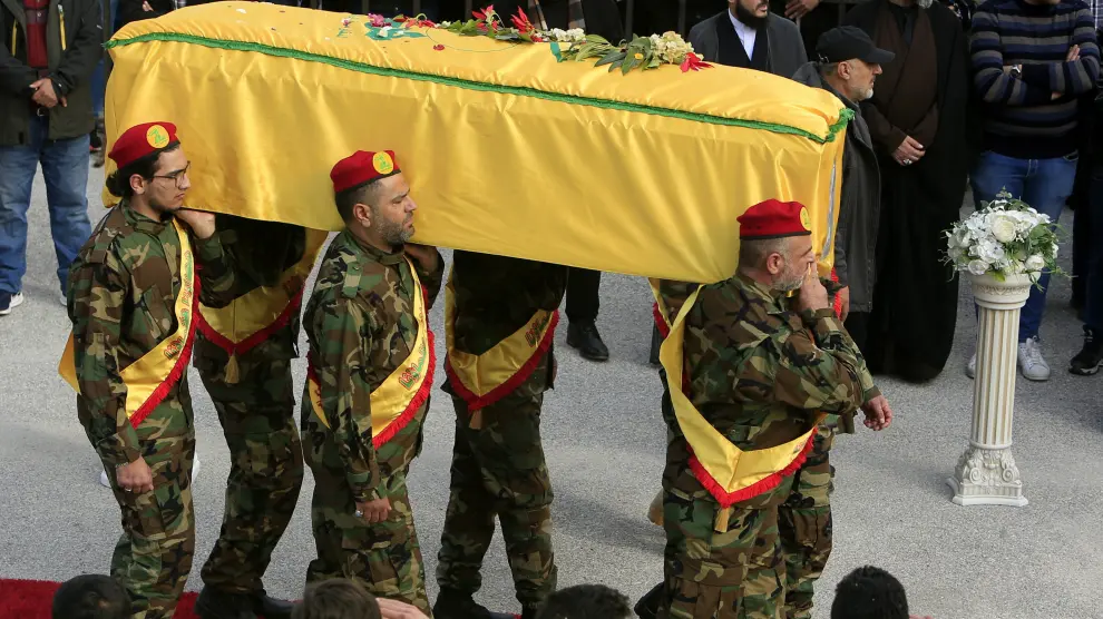 Militantes de Hezbolá llevan el ataúd de un camarada muerto tras los ataques aéreos israelíes durante la procesión fúnebre en la ciudad de Kafr Kila.