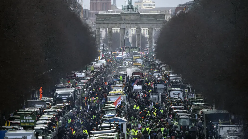 Farmers with tractors arrive for a protest at the Brandenburg Gate in Berlin, Germany, Monday, Jan. 15, 2024. Farmers drove thousands of tractors into Berlin on Monday in the climax of a week of demonstrations against a plan to scrap tax breaks on the diesel they use, a protest that has tapped into wider discontent with Germany’s government. (AP Photo/Ebrahim Noroozi)