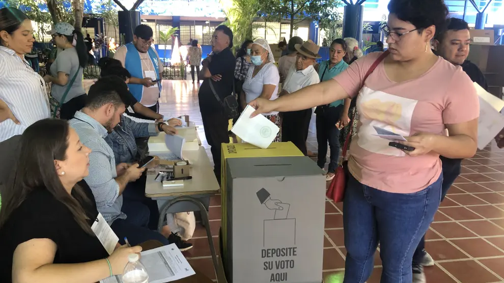 Una joven deposita su voto en el centro electoral Centro Escolar Concha Viuda de Escalón de San Salvador.