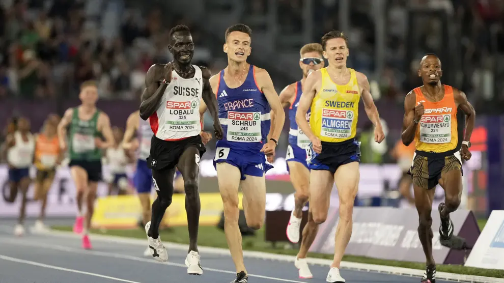 Dominic Lokinyomo Lobalu, of Switzerland, Yann Schrub, of France, Andreas Almgren, of Sweden, and Thierry Ndikumwenayo, of Spain, approach the finish line to win the men's 10000 meters A-race at the European Athletics Championships in Rome, Wednesday, June 12, 2024. (AP Photo/Stefano Costantino)