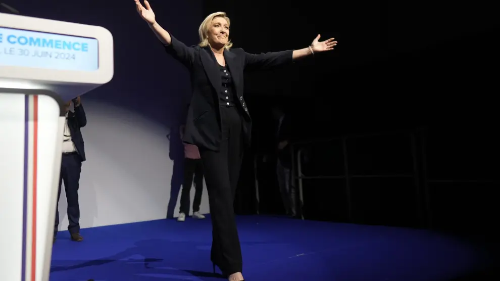 French far right leader Marine Le Pen gestures after delivering her speech after the release of projections based on the actual vote count in select constituencies , Sunday, June 30, 2024 in Henin-Beaumont, northern France. French voters propelled the far-right National Rally to a strong lead in first-round legislative elections Sunday and plunged the country into political uncertainty, according to polling projections. (AP Photo/Thibault Camus)