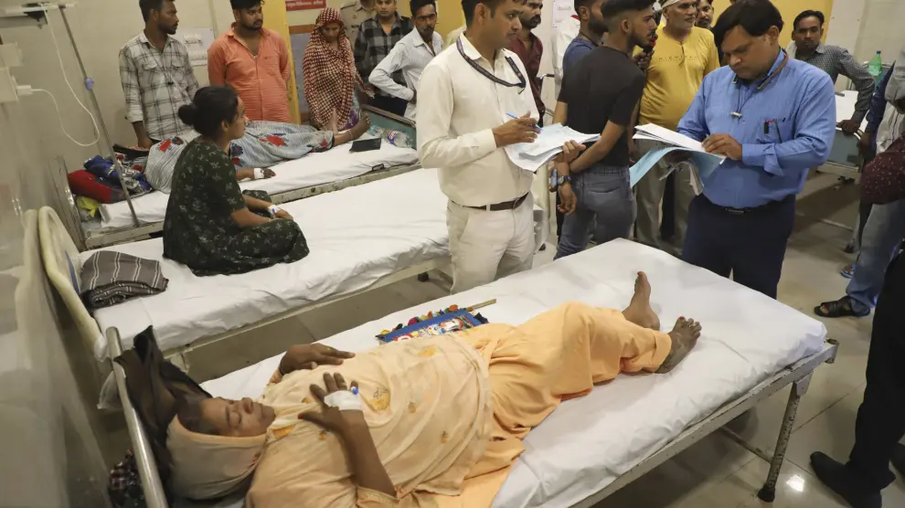 People injured in a stampede receive treatment at Pandit Deendayal hospital in Aligarh, Uttar Pradesh, India, Wednesday, July 3, 2024. More than 100 people died in a stampede after a religious gathering in northern India, making it one of the deadliest such accidents in recent years. (AP Photo/Manoj Aligadi)