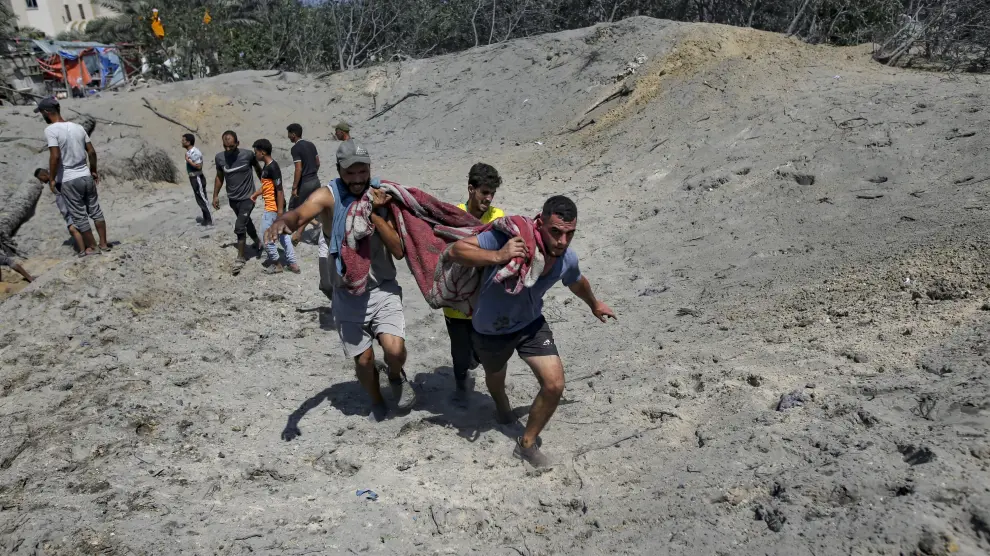 Palestinos evacuando el cadáver de una persona tras el ataque de Hamas