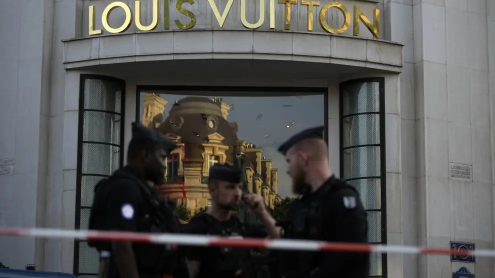 Police officers stand guard at the Louis Vuitton store on the Champs-Elysees avenue, after a stabbing Thursday, July 18, 2024 in Paris. French Interior Minister Gerald Darmanin said a police officer was attacked in Paris on Thursday in the Champs-Elysees neighborhood and the assailant was immediately "neutralized," just days before the opening ceremony of the Summer Olympics. (AP Photo/David Goldman)
