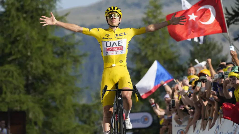 Slovenia's Tadej Pogacar, wearing the overall leader's yellow jersey, takes his fifth stage victory as he crosses the finish line to win the twentieth stage of the Tour de France cycling race over 132.8 kilometers (82.5 miles) with start in Nice and finish in La Couillole pass, France, Saturday, July 20, 2024. (AP Photo/Jerome Delay)