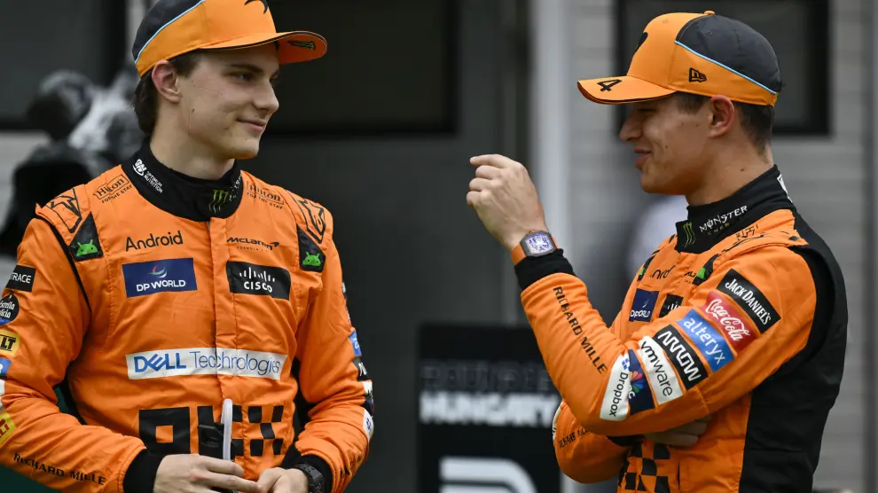 McLaren driver Lando Norris of Britain, right, speaks with McLaren driver Oscar Piastri of Australia after setting the pole position in the qualifying session ahead of Sunday's Formula One Hungarian Grand Prix auto race, at the Hungaroring racetrack in Mogyorod, near Budapest, Hungary, Saturday, July 20, 2024. (AP Photo/Denes Erdos)