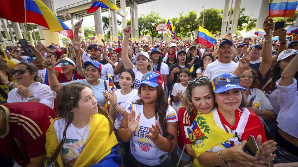 People sing and cheer during a Venezuelan song at a rally at Jose Marti Gym held in support of a fair election on Venezuela's Election Day on Sunday, July 28, 2024, in Miami. (Alie Skowronski/Miami Herald via AP)