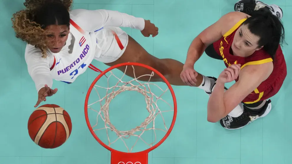 India Pagan, of Puerto Rico, shoots over Megan Gustafson, of Spain, in a women's basketball game at the 2024 Summer Olympics, Wednesday, July 31, 2024, in Villeneuve-d'Ascq, France. (Brian Snyder/Pool Photo via AP)