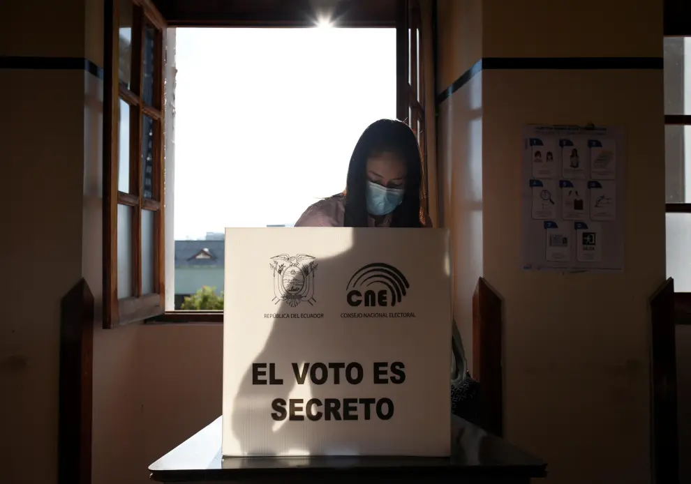 A man casts his vote at a polling station during the presidential election, in Quito, Ecuador February 7, 2021. The writing on the ballot box reads The ECUADOR-ELECTION/