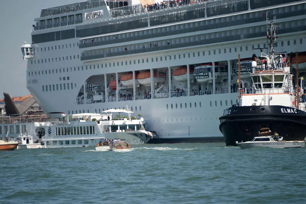 Venice (Italy), 02/06/2019.- The cruise ship MSC Opera is seen after the collision with a tourist boat, in Venice, Italy, 02 June 2019. The cruise ship smashed into a dock located on the Giudecca canal in Venice this morning. Tugs could not maintain control of the MSC cruise ship as it struck the dock and then struck the stern of the 'River Countess' tourist boat (L) which was docked. Four people were taken to the hospital, according to reports. (Italia, Niza, Venecia) EFE/EPA/ANDREA MEROLA Cruise ship collides with tourist boat in Venice