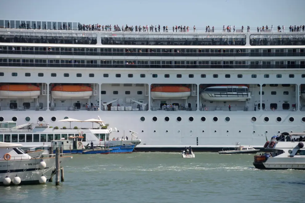 Venice (Italy), 02/06/2019.- The cruise ship MSC Opera (R) is seen after the collision with a tourist boat, in Venice, Italy, 02 June 2019. The cruise ship smashed into a dock located on the Giudecca canal in Venice this morning. Tugs could not maintain control of the MSC cruise ship as it struck the dock and then struck the stern of the 'River Countess' tourist boat (L) which was docked. Four people were taken to the hospital, according to reports. (Italia, Niza, Venecia) EFE/EPA/ANDREA MEROLA Cruise ship collides with tourist boat in Venice