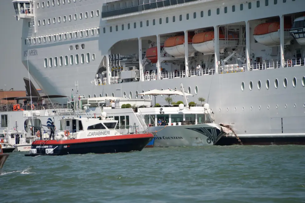 Venice (Italy), 02/06/2019.- The cruise ship MSC Opera (back) is seen after the collision with a tourist boat, in Venice, Italy, 02 June 2019. The cruise ship smashed into a dock located on the Giudecca canal in Venice this morning. Tugs could not maintain control of the MSC cruise ship as it struck the dock and then struck the stern of the 'River Countess' tourist boat (front) which was docked. Four people were taken to the hospital, according to reports. (Italia, Niza, Venecia) EFE/EPA/ANDREA MEROLA Cruise ship collides with tourist boat in Venice