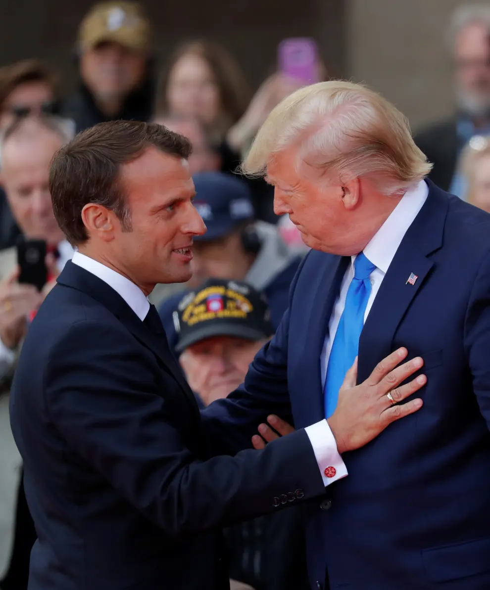 U.S President Donald Trump and French President Emmanuel Macron react during the commemoration ceremony for the 75th anniversary of D-Day at the American cemetery of Colleville-sur-Mer in Normandy, France, June 6, 2019. REUTERS/Carlos Barria [[[REUTERS VOCENTO]]] DDAY-ANNIVERSARY/USA-TRUMP-MACRON