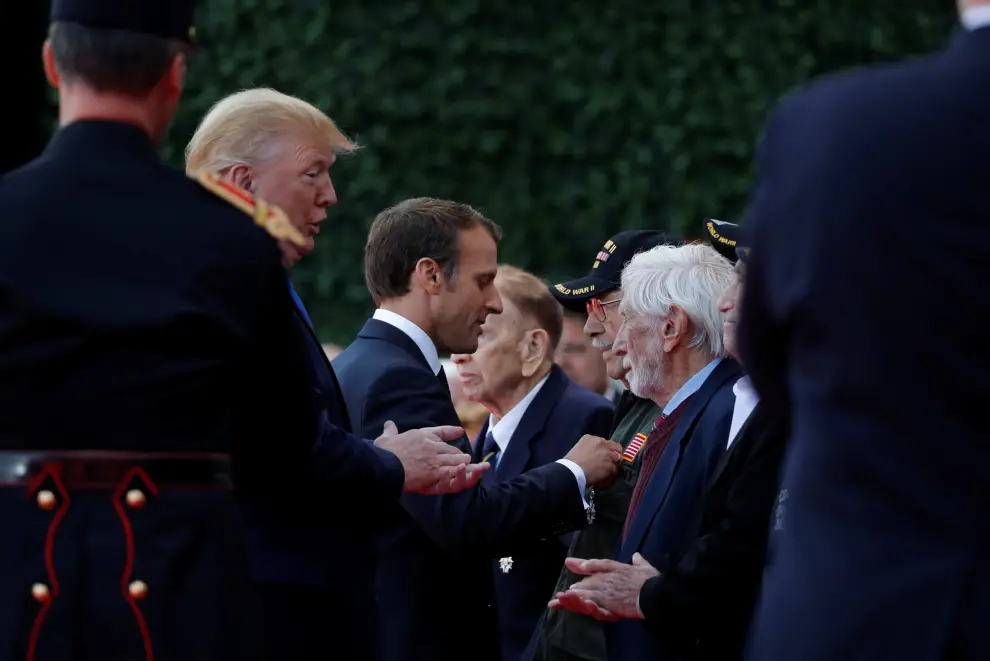 U.S President Donald Trump greets French President Emmanuel Macron during a ceremony to mark the 75th anniversary of the D-Day at the Normandy American Cemetery and Memorial in Colleville-sur-Mer, France, June 6, 2019. REUTERS/Christian Hartmann [[[REUTERS VOCENTO]]] DDAY-ANNIVERSARY/FRANCE