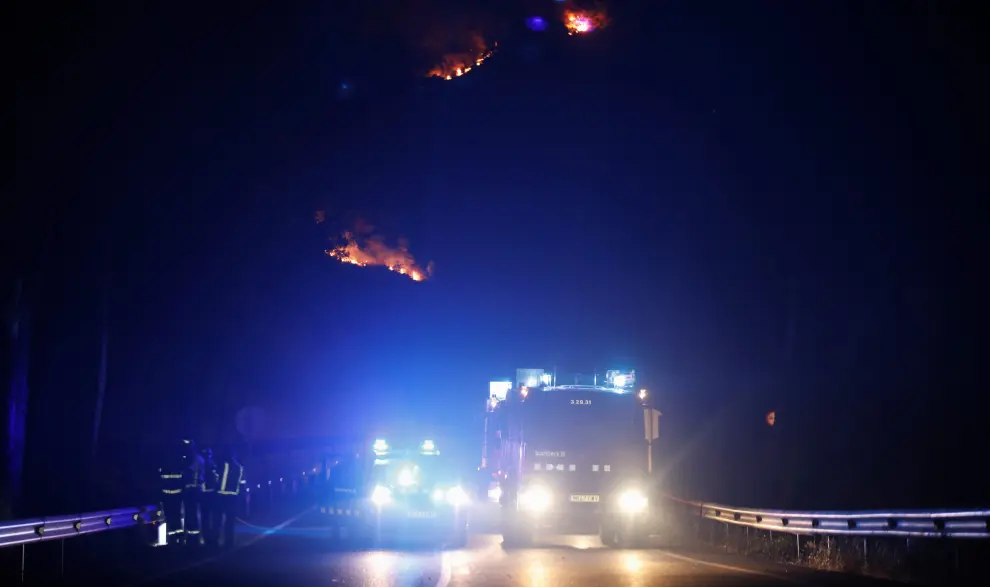 Farmers with their tractors travel down a road to set up firewalls and remove dry plants during a forest fire near Maials, west of Tarragona, Spain, June 27, 2019. REUTERS/Albert Gea [[[REUTERS VOCENTO]]] EUROPE-WEATHER/SPAIN-FIRE