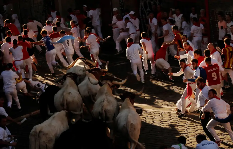 A reveller is helped by medical staff during the running of the bulls at the San Fermin festival in Pamplonaa, Spain, July 11, 2019. REUTERS/Susana Vera [[[REUTERS VOCENTO]]] SPAIN-CULTURE/BULLS