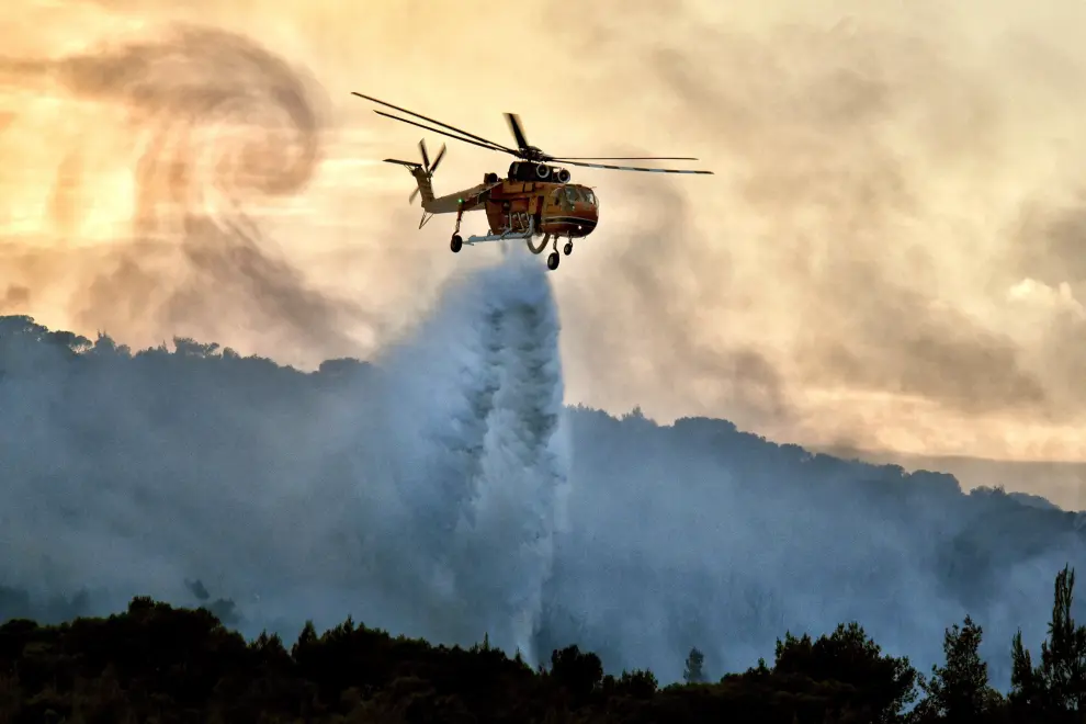 Agioi Theodoroi (Greece), 10/07/2019.- A firefighting plane tries to extinguish the wildfire that break at the area of Agioi Theodoroi, outside of Corinthe city, Peloponnese, southern Greece, 10 July 2019 (issued 11 July 2019). 64 firefighters, 24 land vehicles, 3 aircraft, 3 helicopters and 2 water wagons battled the fire. (Incendio, Grecia) EFE/EPA/VASSILIS PSOMAS Wildfire at Agioi Theodoroi in Peloponnese.