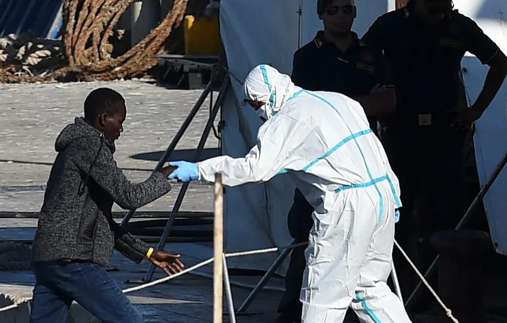 A minor who was among migrants stranded on the Spanish migrant rescue ship Open Arms disembarks in Lampedusa, Italy August 17, 2019. REUTERS/Guglielmo Mangiapane [[[REUTERS VOCENTO]]] EUROPE-MIGRANTS/