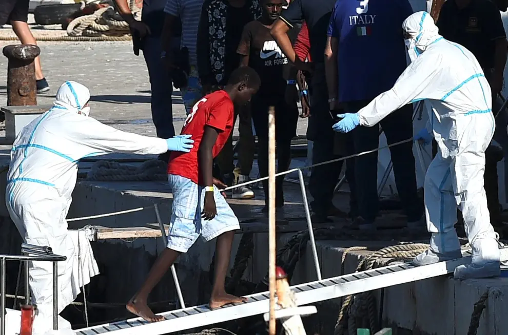A minor who was among migrants stranded on the Spanish migrant rescue ship Open Arms disembarks in Lampedusa, Italy August 17, 2019. REUTERS/Guglielmo Mangiapane [[[REUTERS VOCENTO]]] EUROPE-MIGRANTS/