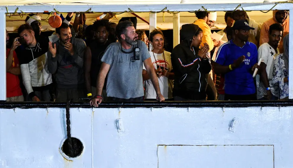 Migrants evacuated by a Spanish rescue ship Open Arms disembark at Lampedusa, Italy in this undated handout picture provided by the Spanish NGO Open Arms on August 19, 2019. Francisco Gentico/Open Arms/Handout via REUTERS ATTENTION EDITORS - THIS IMAGE WAS PROVIDED BY A THIRD PARTY. NO RESALES. NO ARCHIVES. WATERMARKED FROM SOURCE. EUROPE-MIGRANTS/ITALY-SPAIN