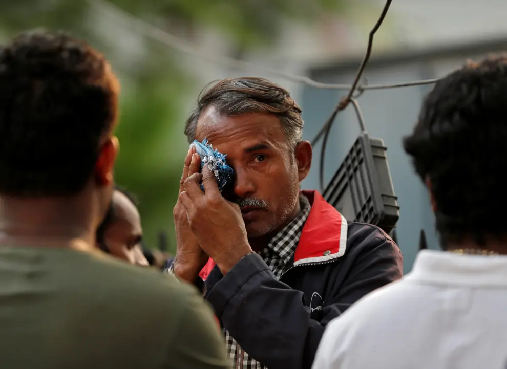 A man wipes his tears as he waits outside a mortuary to receive the body of his relative who died in a fire that swept through a factory where laborers were sleeping, in New Delhi, India, December 8, 2019. REUTERS/Adnan Abidi [[[REUTERS VOCENTO]]] INDIA-FIRE/
