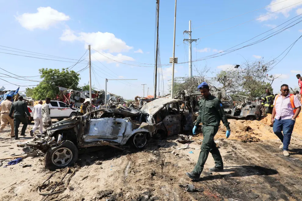 SENSITIVE MATERIAL. THIS IMAGE MAY OFFEND OR DISTURB    A Somali police officer walks at the scene of a car bomb explosion at a checkpoint in Mogadishu, Somalia  December 28, 2019. REUTERS/Feisal Omar [[[REUTERS VOCENTO]]] SOMALIA-BLAST/