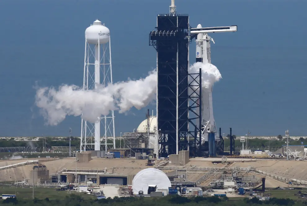 A SpaceX Falcon 9 rocket purges fuel after topping off before scheduled launch in Cape Canaveral