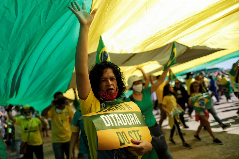 A supporter of Brazilian President Jair Bolsonaro displays a placard reading "Down with the Dictatorship of the Supreme Federal Court" during a protest, amid the coronavirus disease (COVID-19) outbreak, in Brasilia