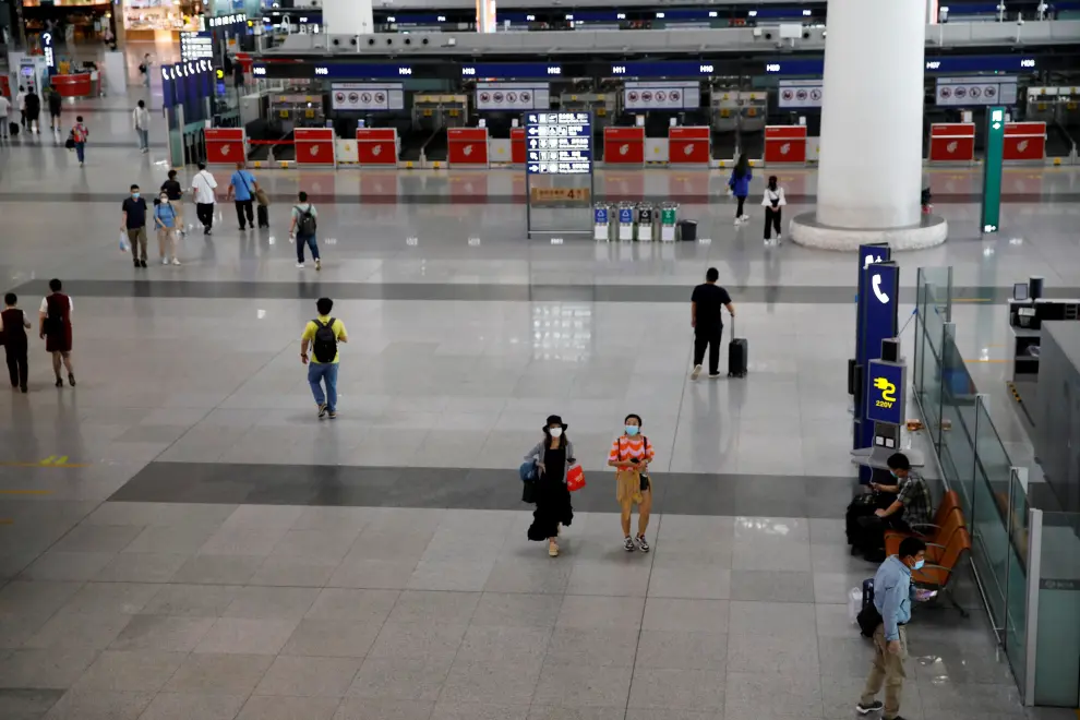People are seen at the departure hall of Beijing Capital International Airport