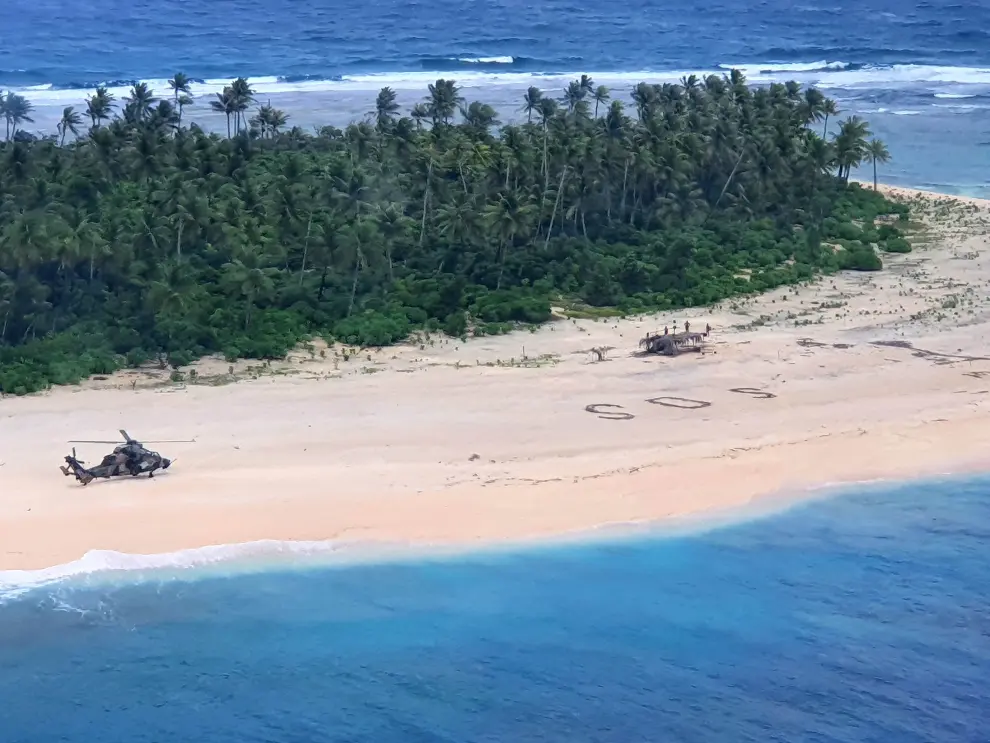 Three men from the Federated States of Micronesia stand on the beach of Pikelot Island, found after a combined U.S. and Australian search, August 2, 2020. Picture taken August 2, 2020. AUSTRALIAN DEPARTMENT OF DEFENCE/Handout via REUTERS THIS IMAGE HAS BEEN SUPPLIED BY A THIRD PARTY. NO RESALES. NO ARCHIVES MANDATORY CREDIT [[[REUTERS VOCENTO]]] AUSTRALIA-SAILORS/SOS