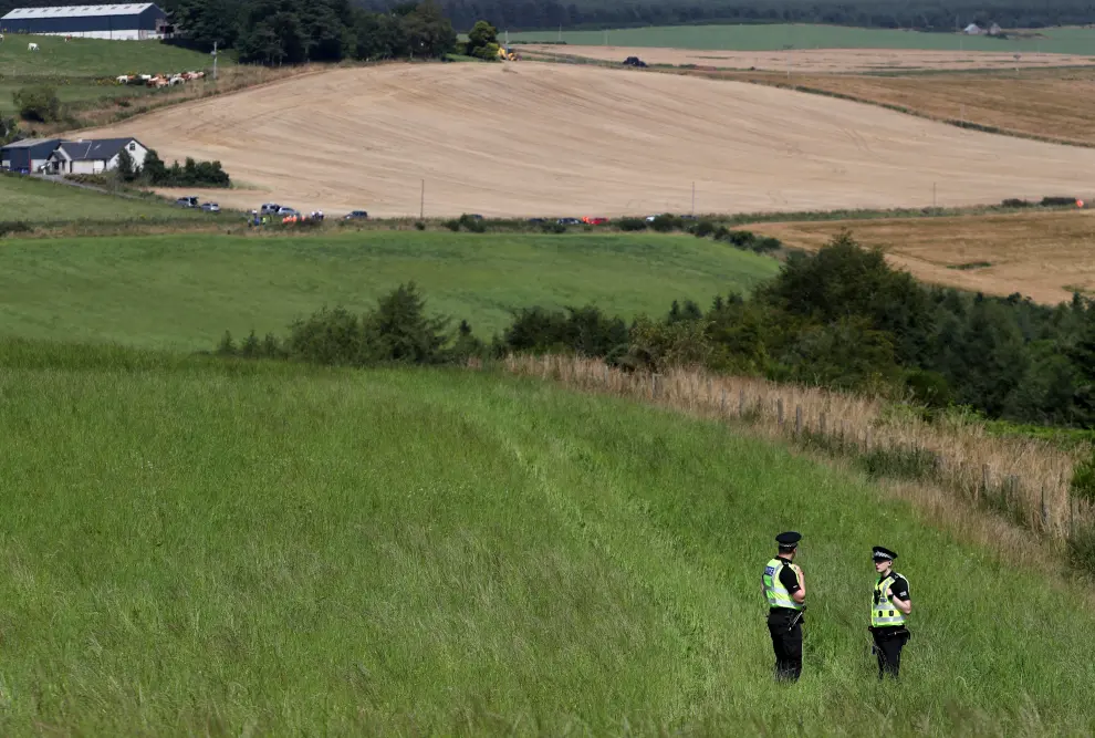 A police officer walks in the area of the scene of a derailed passenger train near Stonehaven in Scotland, Britain, August 12, 2020. REUTERS/Russell Cheyne [[[REUTERS VOCENTO]]] BRITAIN-RAIL/