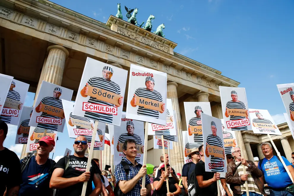 Demonstrators hold placards during a rally against the government's restrictions following the coronavirus disease (COVID-19) outbreak, in Berlin, Germany August 29, 2020. REUTERS/Axel Schmidt [[[REUTERS VOCENTO]]] HEALTH-CORONAVIRUS/GERMANY-PROTEST